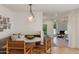 Cozy breakfast nook features booth seating, warm lighting, and a nearby living room at 3186 E Stella Ln, Phoenix, AZ 85016