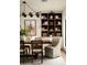Elegant dining room features a dark wood table, stylish chairs, a modern chandelier, and built-in shelving at 3186 E Stella Ln, Phoenix, AZ 85016