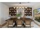 This dining room features custom built-ins, stylish lighting, and backyard views at 3186 E Stella Ln, Phoenix, AZ 85016