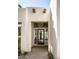 Home entryway features a modern glass front door with wooden beams and a modern light fixture at 3186 E Stella Ln, Phoenix, AZ 85016