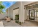 Inviting front entrance features stone landscaping, charming outdoor seating, and a glass door at 3186 E Stella Ln, Phoenix, AZ 85016