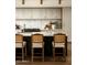 Beautiful kitchen island featuring stone countertops, wooden stools, and modern lighting at 3186 E Stella Ln, Phoenix, AZ 85016