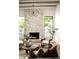 Bright living room features a stone fireplace, wood floors, and large windows at 3186 E Stella Ln, Phoenix, AZ 85016