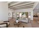 Bright living room features wood beam ceiling and seamless indoor-outdoor flow at 3186 E Stella Ln, Phoenix, AZ 85016