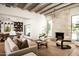 Living room with stone fireplace, vaulted ceilings, and a view to the dining area at 3186 E Stella Ln, Phoenix, AZ 85016