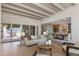 Bright living room showcases seamless flow into dining room, high ceilings, and stylish decor at 3186 E Stella Ln, Phoenix, AZ 85016