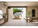 Covered outdoor living space with seating, travertine tile, and a view of the sparkling pool at 3186 E Stella Ln, Phoenix, AZ 85016