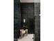 Modern shower featuring dark tile, sleek fixtures, and a stylish wooden stool with a plant at 3186 E Stella Ln, Phoenix, AZ 85016