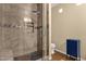 Modern bathroom with tiled shower featuring glass door and bench seating at 3221 N 37Th St # 10, Phoenix, AZ 85018