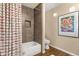 Bathroom showcasing shower and tub combination, neutral walls and wood look floors at 3221 N 37Th St # 10, Phoenix, AZ 85018