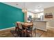 The dining room boasts a table, seating for six, and a vibrant teal accent wall at 3221 N 37Th St # 10, Phoenix, AZ 85018