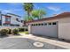 Home exterior featuring a garage with a gray door and desert landscaping at 3221 N 37Th St # 10, Phoenix, AZ 85018
