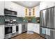 This kitchen includes stainless steel appliances, a modern backsplash, and ample counter space at 3221 N 37Th St # 10, Phoenix, AZ 85018