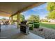 Spacious covered patio with a built in grill overlooking the meticulously landscaped backyard at 32311 N Cat Hills Ave, San Tan Valley, AZ 85144
