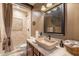 Stylish bathroom with a stone vessel sink, elegant fixtures, and a luxurious, spa-like shower area at 32311 N Cat Hills Ave, San Tan Valley, AZ 85144