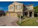 Charming two-story home featuring a three-car garage, desert landscaping and shuttered windows at 32311 N Cat Hills Ave, San Tan Valley, AZ 85144