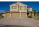 Beautiful home featuring a three-car garage and manicured front lawn on a sunny day at 32311 N Cat Hills Ave, San Tan Valley, AZ 85144