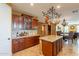 Well-appointed kitchen featuring granite countertops, a center island, and access to the dining and living areas at 32311 N Cat Hills Ave, San Tan Valley, AZ 85144