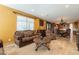 Open-concept living room featuring a blend of traditional furnishings, tile floors, and neutral walls at 32311 N Cat Hills Ave, San Tan Valley, AZ 85144