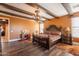 Luxurious main bedroom with wood floors, exposed beams, and ornate furniture at 32311 N Cat Hills Ave, San Tan Valley, AZ 85144