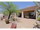 Stunning desert home with spacious covered patio, outdoor kitchen, fireplace, and desert landscaping at 32516 N 68Th Pl, Scottsdale, AZ 85266
