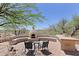 Entertain in style with backyard fireplace, outdoor kitchen area, built-in seating, and beautiful desert views at 32516 N 68Th Pl, Scottsdale, AZ 85266