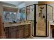 Bathroom features granite countertop, dark cabinets, and walk-in shower at 32516 N 68Th Pl, Scottsdale, AZ 85266