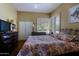 Bedroom with warm paint, shutters and closet at 32516 N 68Th Pl, Scottsdale, AZ 85266