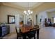 This dining room showcases neutral tones, a chandelier, and travertine floors at 32516 N 68Th Pl, Scottsdale, AZ 85266