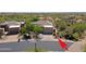 Desert home features a red tile roof, a two-car garage and mature landscaping at 32516 N 68Th Pl, Scottsdale, AZ 85266