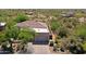 Desert home features a red tile roof, a two-car garage and mature landscaping at 32516 N 68Th Pl, Scottsdale, AZ 85266