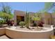 Single-story Southwestern home featuring a walled front yard with desert landscaping at 32516 N 68Th Pl, Scottsdale, AZ 85266