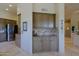 This kitchen features stainless appliances, a travertine floor, and custom cabinets at 32516 N 68Th Pl, Scottsdale, AZ 85266