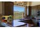 Spacious kitchen featuring stainless steel appliances, tile backsplash and custom cabinets at 32516 N 68Th Pl, Scottsdale, AZ 85266