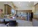 Modern kitchen featuring stainless steel appliances, custom cabinets, and a breakfast bar at 32516 N 68Th Pl, Scottsdale, AZ 85266