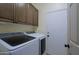 Clean laundry room with white cabinets and washer and dryer at 32516 N 68Th Pl, Scottsdale, AZ 85266