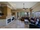 Comfortable living room with fireplace, leather couches, and scenic outdoor views at 32516 N 68Th Pl, Scottsdale, AZ 85266