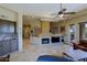 Open-concept living space with a fireplace, and views into the kitchen at 32516 N 68Th Pl, Scottsdale, AZ 85266