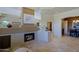 Bright and open living room boasting a cozy fireplace and view into the kitchen at 32516 N 68Th Pl, Scottsdale, AZ 85266