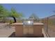 Built-in outdoor stainless steel gas grill in backyard with desert landscaping, ideal for entertaining at 32516 N 68Th Pl, Scottsdale, AZ 85266