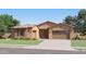 Charming single-story home with desert landscaping, a stone facade, and a two-car garage at 3385 E Saddletree Way, San Tan Valley, AZ 85140