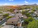 Expansive aerial view of a beautiful home featuring a backyard pool and putting green with mountain views at 3859 N El Sereno St, Mesa, AZ 85207