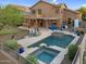 Aerial view of backyard showcasing a pool, spa, putting green, outdoor kitchen and dining at 3859 N El Sereno St, Mesa, AZ 85207