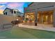 Exterior of home with covered patio and outdoor kitchen, backyard putting green, and desert landscaping at 3859 N El Sereno St, Mesa, AZ 85207