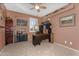 Spacious bedroom featuring dark wood desk and salmon color walls with decorative fishing decor at 3859 N El Sereno St, Mesa, AZ 85207
