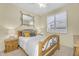 Bedroom with earth tone walls, natural wood bed frame and shuttered window at 3859 N El Sereno St, Mesa, AZ 85207
