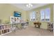 Craft room with yellow walls, sewing machine, desk with chair and ceiling fan at 3859 N El Sereno St, Mesa, AZ 85207