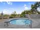 Inviting hot tub with a safety railing, stone accents, and desert landscaping providing a tranquil retreat at 3859 N El Sereno St, Mesa, AZ 85207