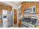 Modern kitchen featuring stainless steel appliances, granite countertops, and ample cabinet space for storage at 3859 N El Sereno St, Mesa, AZ 85207