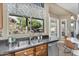 Kitchen sink below a large window overlooking the landscaped backyard at 3859 N El Sereno St, Mesa, AZ 85207
